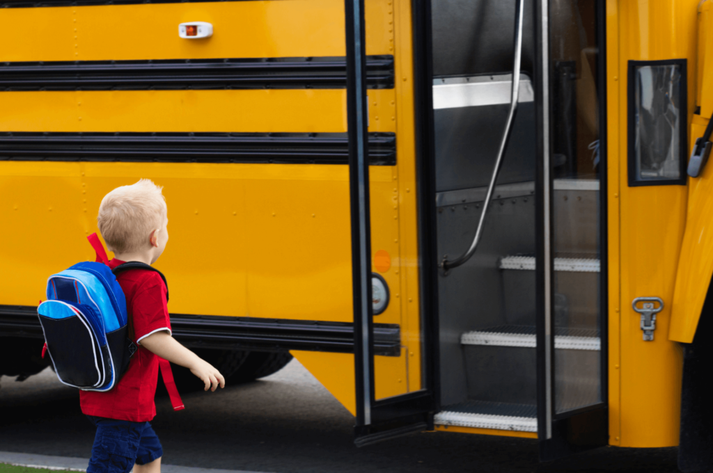 Boy walking onto school bus